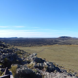 Dark volcanic rocks overlooking the open landscape of Pali-Aike National Park