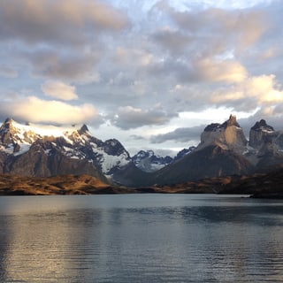 Clouds breaking above a lake and the mountains of Torres del Paine